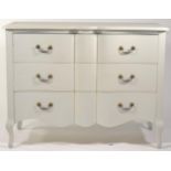 The Sleep Room: A Cream Painted Serpentine Chest, of modern date, with three deep drawers, raised on