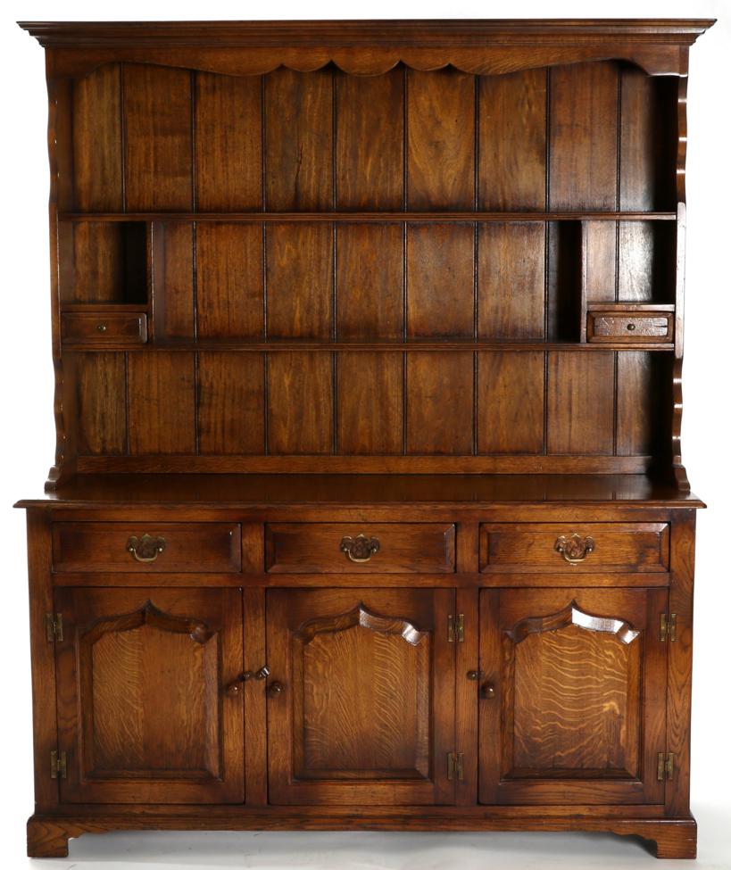 A Reproduction Oak Enclosed Dresser, of recent date, the upper section with two shelves and two