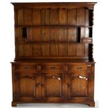 A Reproduction Oak Enclosed Dresser, of recent date, the upper section with two shelves and two