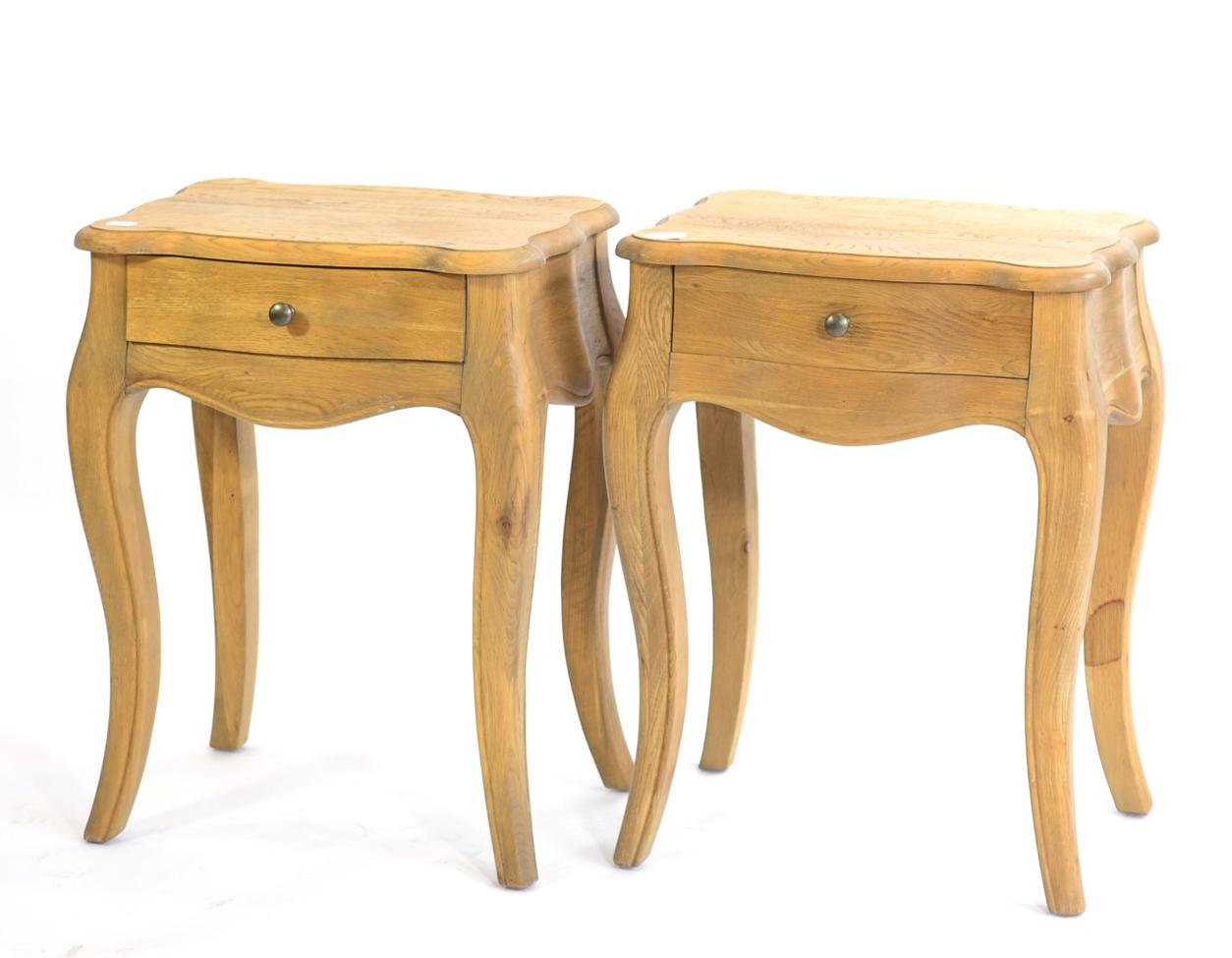 A Pair of Reproduction French Style Oak Bedside Tables, of recent date, of serpentine shaped form,