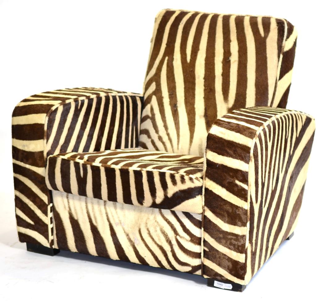 A 20th Century Armchair, upholstered in zebra skin, with padded back support and seat, with square