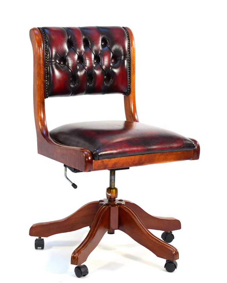 A Reproduction Mahogany Swivel Office Armchair, of recent date, upholstered in close-nailed and ox