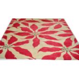 A Luke Irwin Modernist Hand Knotted Carpet of Poinsettia Design, the ivory field of large flower