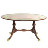 A Reproduction Mahogany Oval Coffee Table, in Regency style, with a green and gilt leather top,