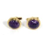 A pair of 9 carat gold amethyst cufflinks, round cabochon amethyst in rubbed over settings, to