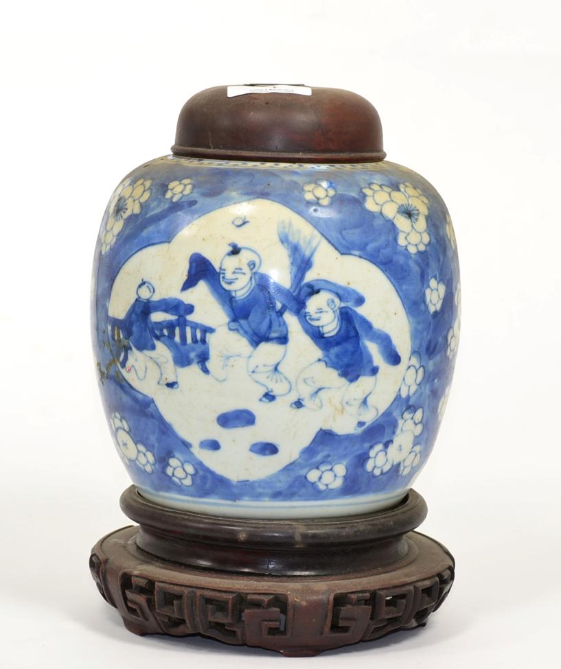 A Chinese porcelain cracked ice ginger jar, decorated with children playing, with a later wooden