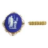 A Wedgwood blue Jasperware brooch, the oval plaque depicting Nike, in a scroll frame, measures 6.5cm