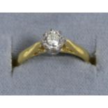 An 18 carat gold solitaire diamond ring, a round brilliant cut diamond in a claw setting, to knife