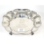 A shaped circular silver bowl, Thomas Bradbury, Sheffield 1930, on four scroll supports, with