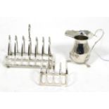 A silver toast rack, London 1901; another smaller example, Elkington, 1935; and a George III style