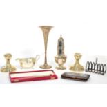Assorted silver items comprising: a pair of candlesticks Elkington & Co, 1967; a sauceboat, 1930;