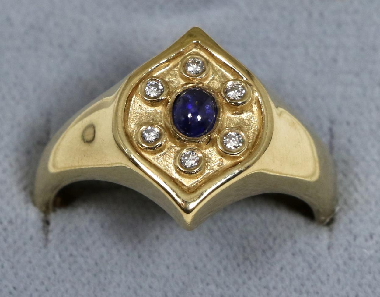 A 9 carat gold sapphire and diamond cluster ring, an oval cabochon sapphire within a border of round