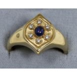A 9 carat gold sapphire and diamond cluster ring, an oval cabochon sapphire within a border of round
