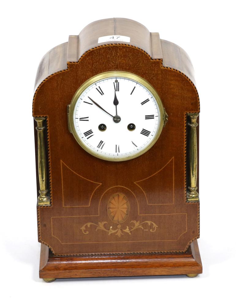 An Edwardian mahogany inlaid striking mantle clock