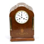 An Edwardian mahogany inlaid striking mantle clock