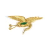 A jade and ruby crane brooch, modelled in a flying pose, with textured feathers, inset with a