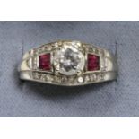 An Art Deco style ruby and diamond ring, a round brilliant cut diamond in a claw setting, spaced