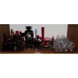 A collection of decorative glass including ruby and cranberry; Carnival glass plates; a ship