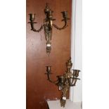 A pair of gilt metal three light wall sconces