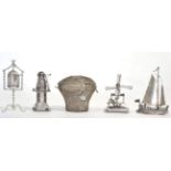 Two Dutch silver miniature models of windmills; a Dutch silver model of a boat; a model of a