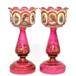 A pair of 19th century cranberry table lustres, each of baluster stemmed form, painted with