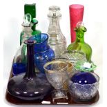 A tray of early 19th century and later glass including ring neck decanters, coloured glass etc