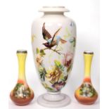 A Continental opaque glass vase painted with a garden bird perched on a branch amongst flowers;