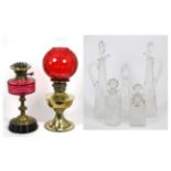 Two oil lamps and five glass decanters with stoppers