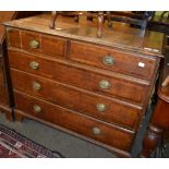 An early 19th century oak chest of drawers comprising four long drawers and two short drawers