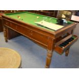 A Bar Billiards games table with billiard balls and three billiard cues