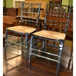 A pair of ebonised rush seated chairs and three oak dining chairs (a.f.) (5)
