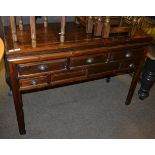 A 20th century sideboard with three long drawers above two short drawers