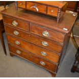 An early 19th century mahogany chest of drawers comprising three long drawers and two short drawers