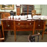 A George III mahogany and tulip wood banded serpentine shaped sideboard with brass gallery rail,