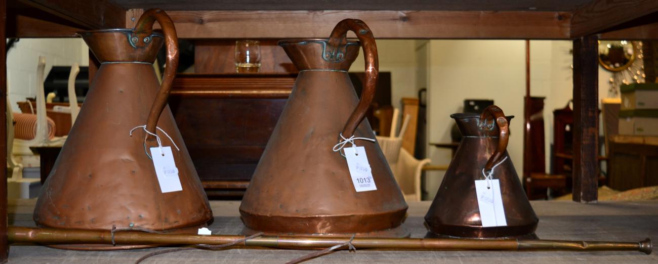 Three 19th century copper harvest jugs and a copper hunting horn (4)