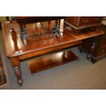 A Victorian mahogany dining table with one extra leaf