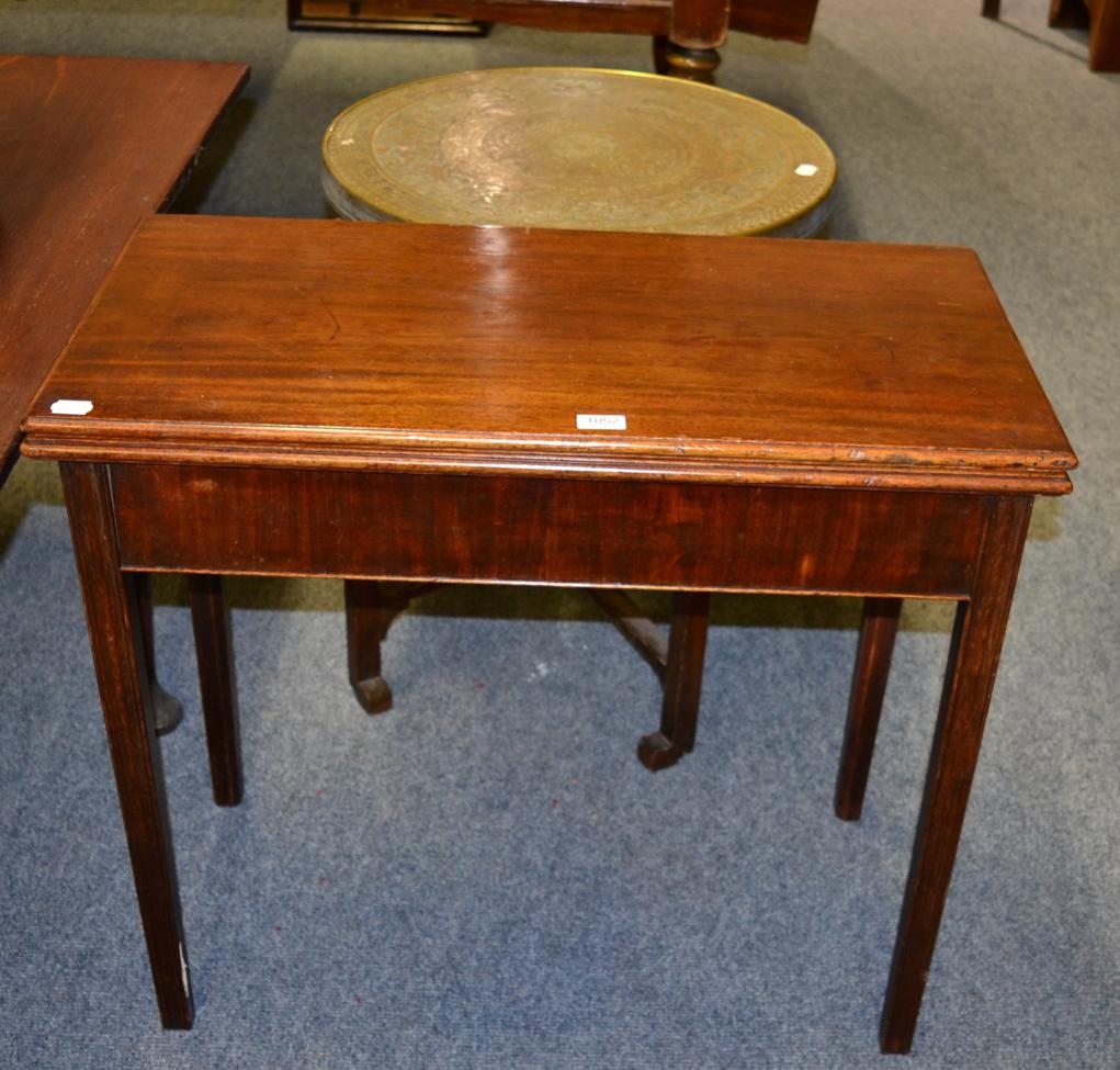 A mahogany fold over tea table and an Indian style copper topped table with folding wooden base