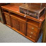 A mahogany side cabinet consisting of two small central doors and six side drawers