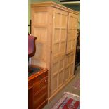 A pine kitchen cabinet with two sets of doors enclosing five interior shelves