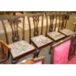 Four mahogany George III style dining chairs, multi coloured tapestry seats, raised upon claw and