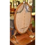 A painted satinwood oval screen retailed by Greenwoods of York with painted swag decoration to the