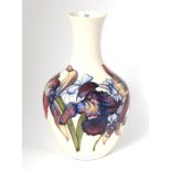 A Walter Moorcroft pottery Orchid and Spring Flowers pattern vase on a white ground, with painted