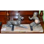 An Art Deco patinated metal figure of a girl playing ball with a recumbent dog