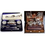 Three George IV silver fiddle pattern table spoons; a cased silver mounted manicure set; a set of