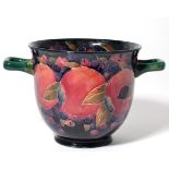 A Moorcroft pottery Pomegranate pattern twin handled vase, with painted and impressed marks, 13.