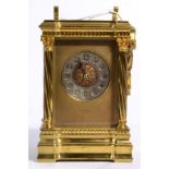 A brass striking carriage clock, dial signed Reid & Sons, Paris, the case with spirally fluted