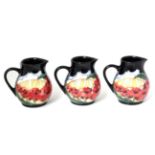 A set of three modern Moorcroft pottery Forever England pattern jugs by Vicky Lovatt, with painted