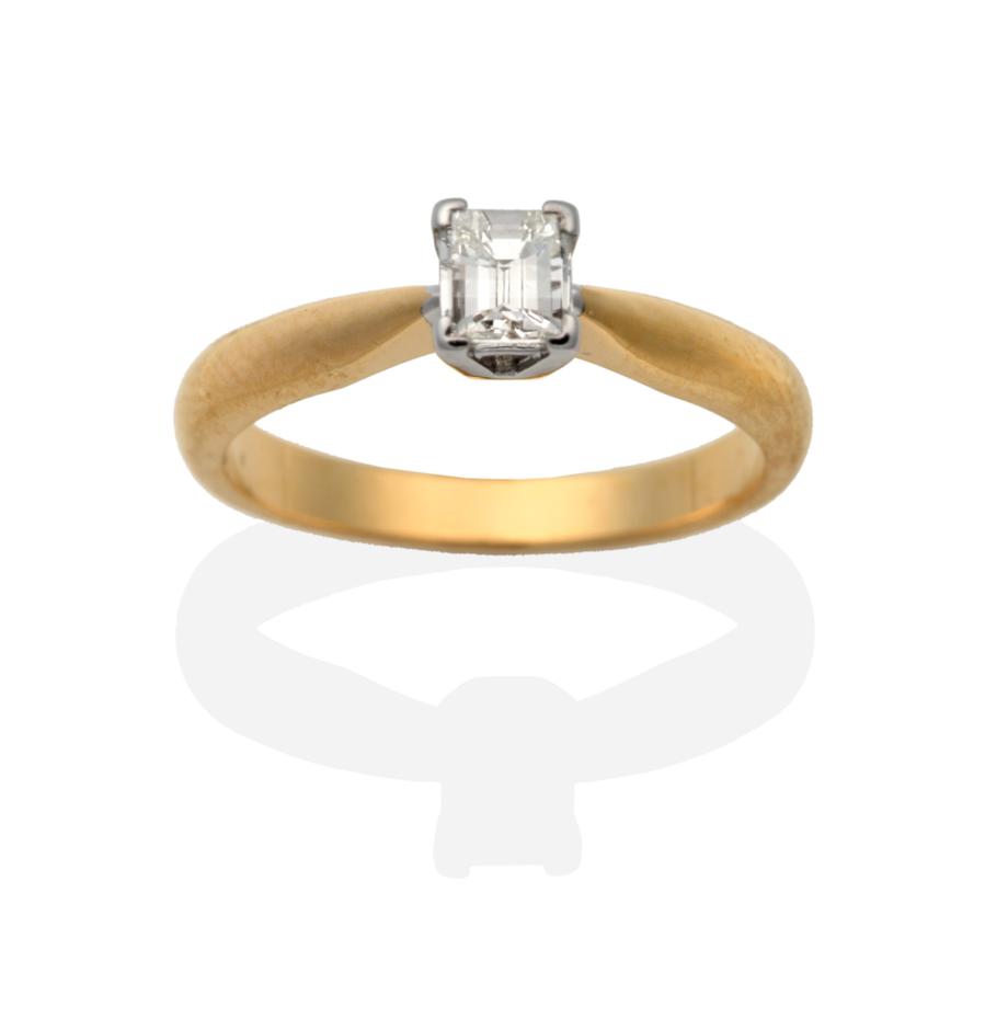 An 18 Carat Gold Millennium Cut Solitaire Diamond Ring, in a claw setting, to knife edge