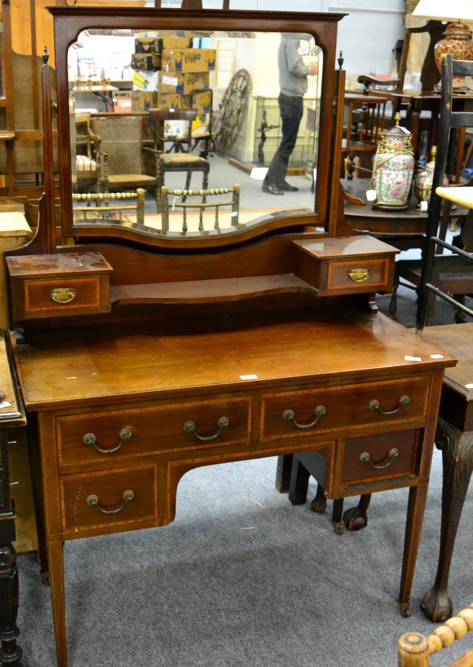 An Edwardian mahogany and satinwood banded dressing table, with two short over two long drawers,