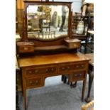 An Edwardian mahogany and satinwood banded dressing table, with two short over two long drawers,